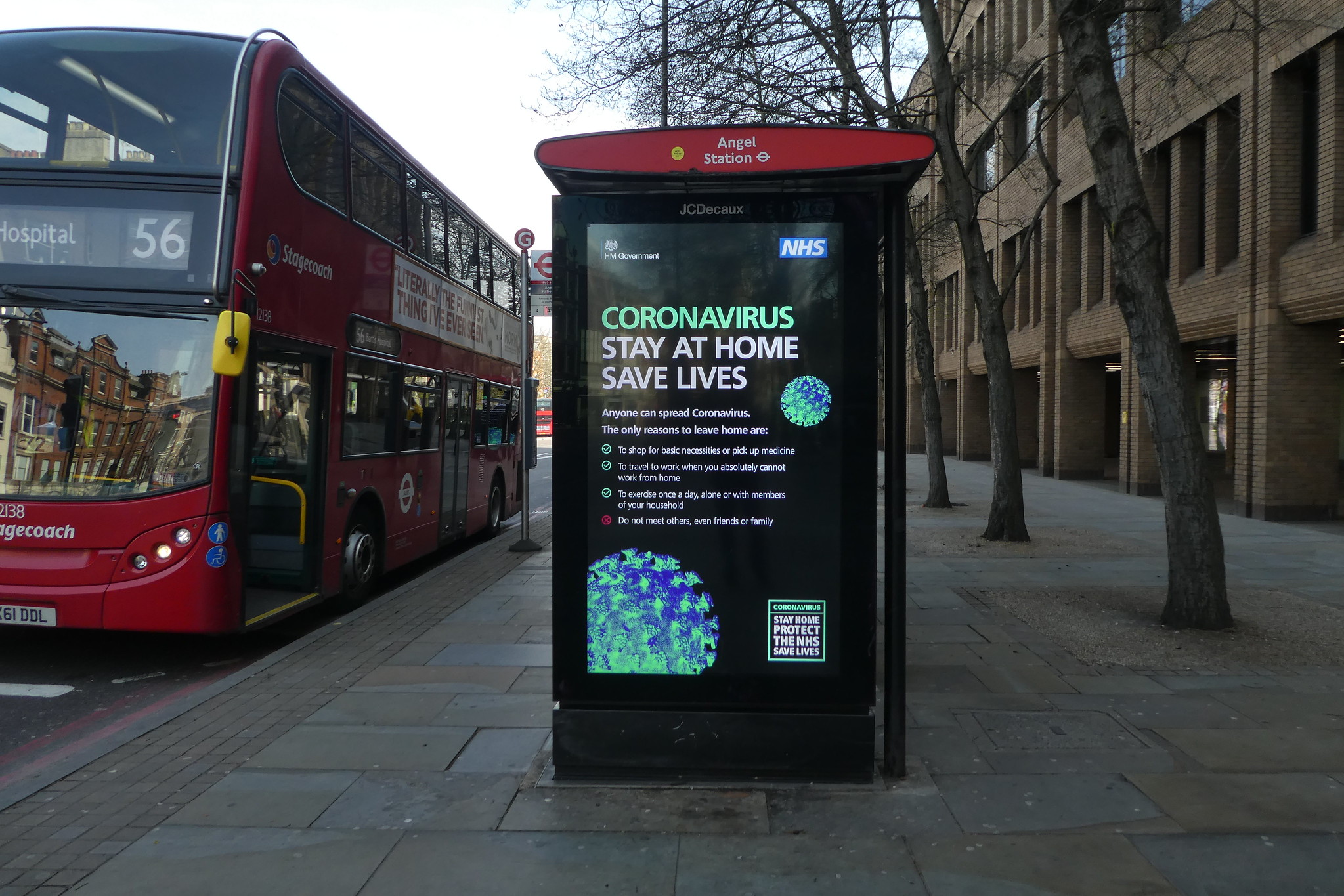 A government advert on a bus stop in London that read ' Stay Home, Protect the NHS, Save Lives'